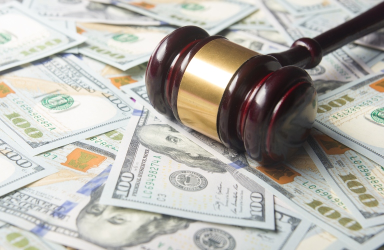Judges gavel on the dollar cash background