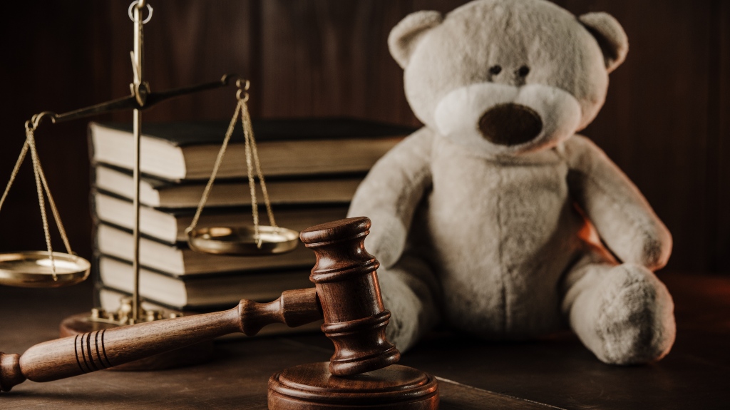 Wooden gavel and teddy bear