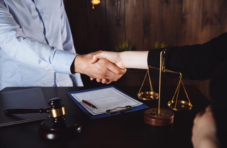 man shaking hands to seal a deal with lawyer