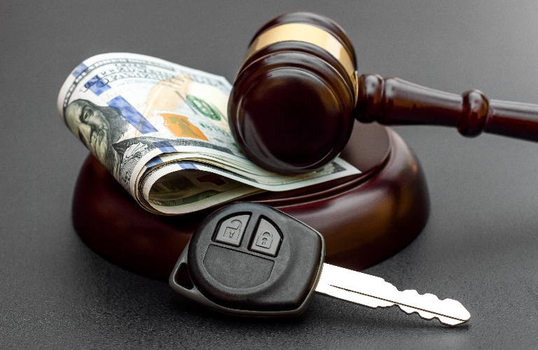Judge's gavel with car key and money