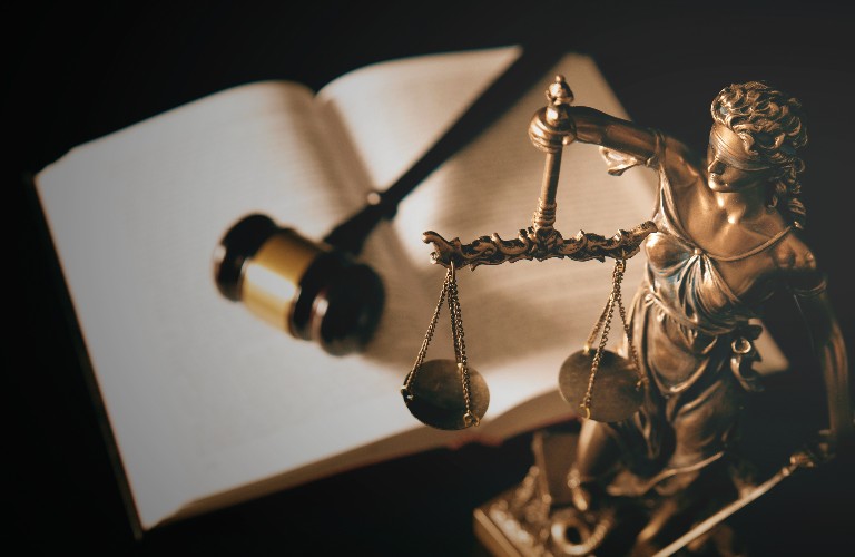 Lady Justice statue and law books