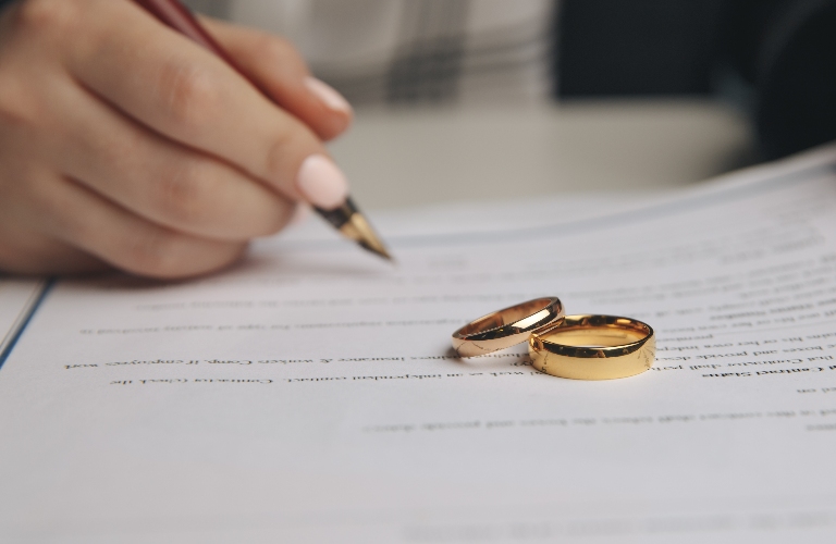 Woman is signing divorce agreement