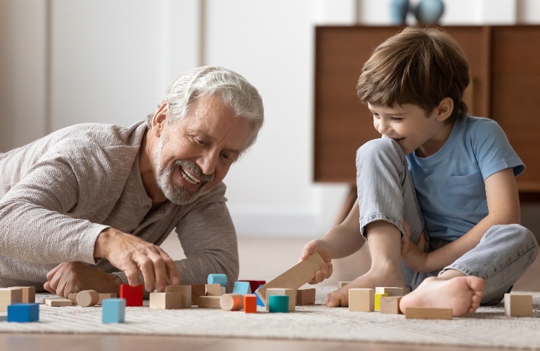 grandfather plays with his little grandson