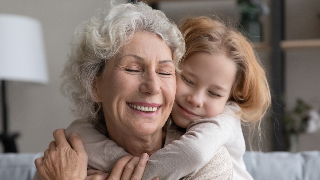 little girl hugs her grandmother