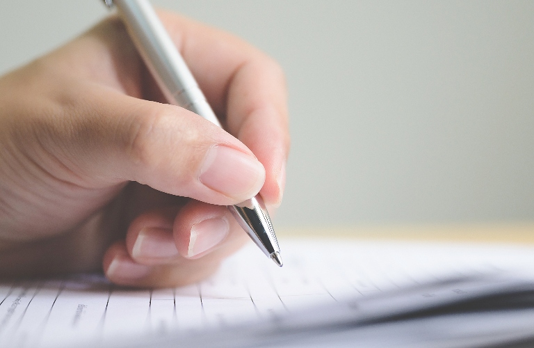 woman is signing document