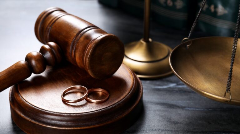 Judge's gavel with wedding rings