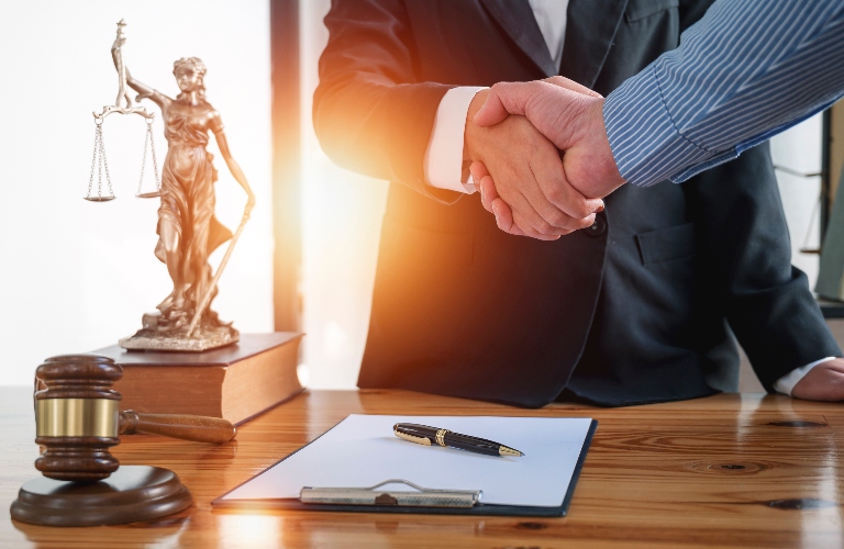 lawyer shakes hands with a client