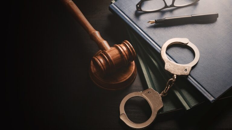 Handcuffs and wooden gavel