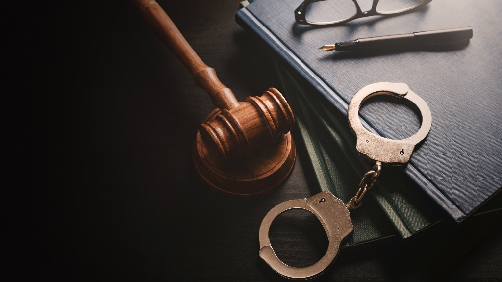 Handcuffs and wooden gavel