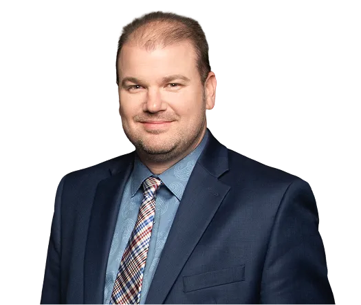 Professional headshot of a man in a navy blue suit, patterned tie, and light blue shirt.