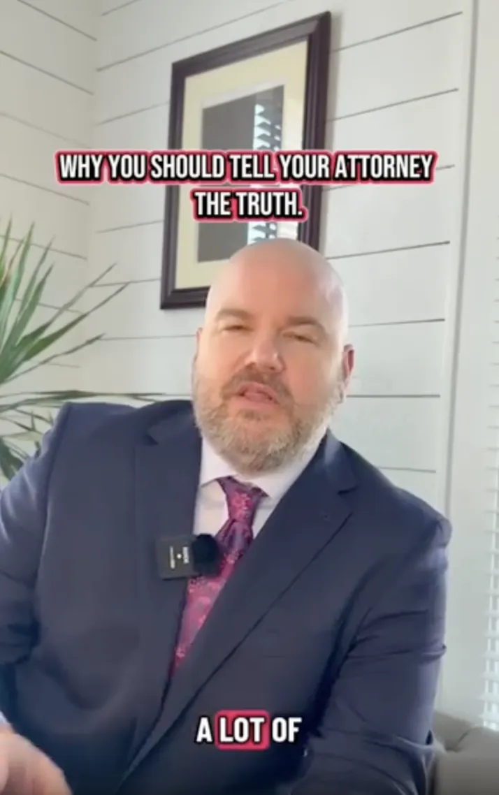 Professional man in suit and tie speaking indoors with text "Why you should tell your attorney the truth.