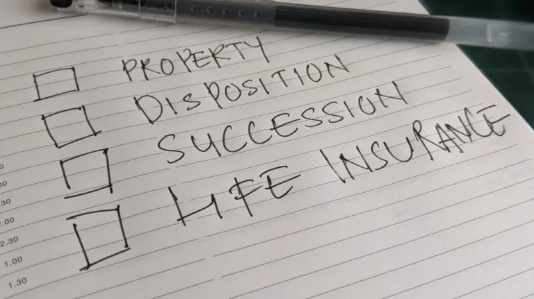 Close-up of a lined notebook page with handwritten checklist including property disposition, succession, and life insurance.